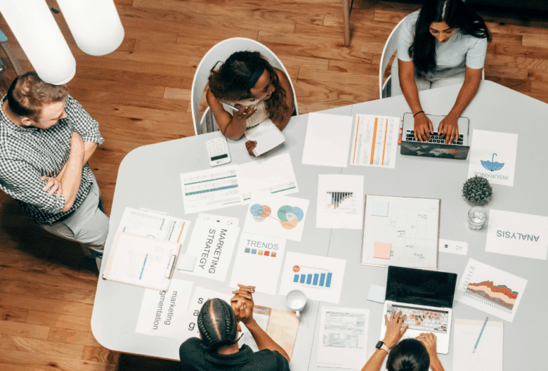 A group of people discuss social media vs. seo vs. paid ads for their small business.
